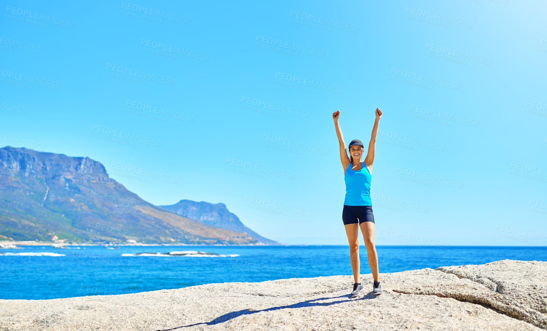 Buy stock photo Fitness, freedom and woman on beach with achievement, space and outdoor training exercise. Ocean, celebration and girl runner with arms up, blue sky and morning workout goals in nature for body care