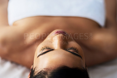 Buy stock photo Shot of an attractive young woman relaxing on a massage table at a spa