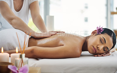 Buy stock photo Shot of an attractive young woman getting a massage at a spa