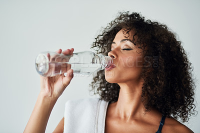 Buy stock photo Drinking water, fitness and hydration with face of woman in studio on white background for health. Bottle, exercise and thirsty with sports person at gym for break, recovery or rest from training