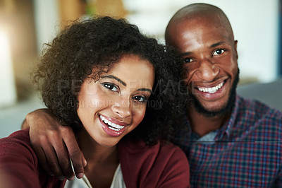 Buy stock photo Portrait of a happy young couple taking selfies together at home