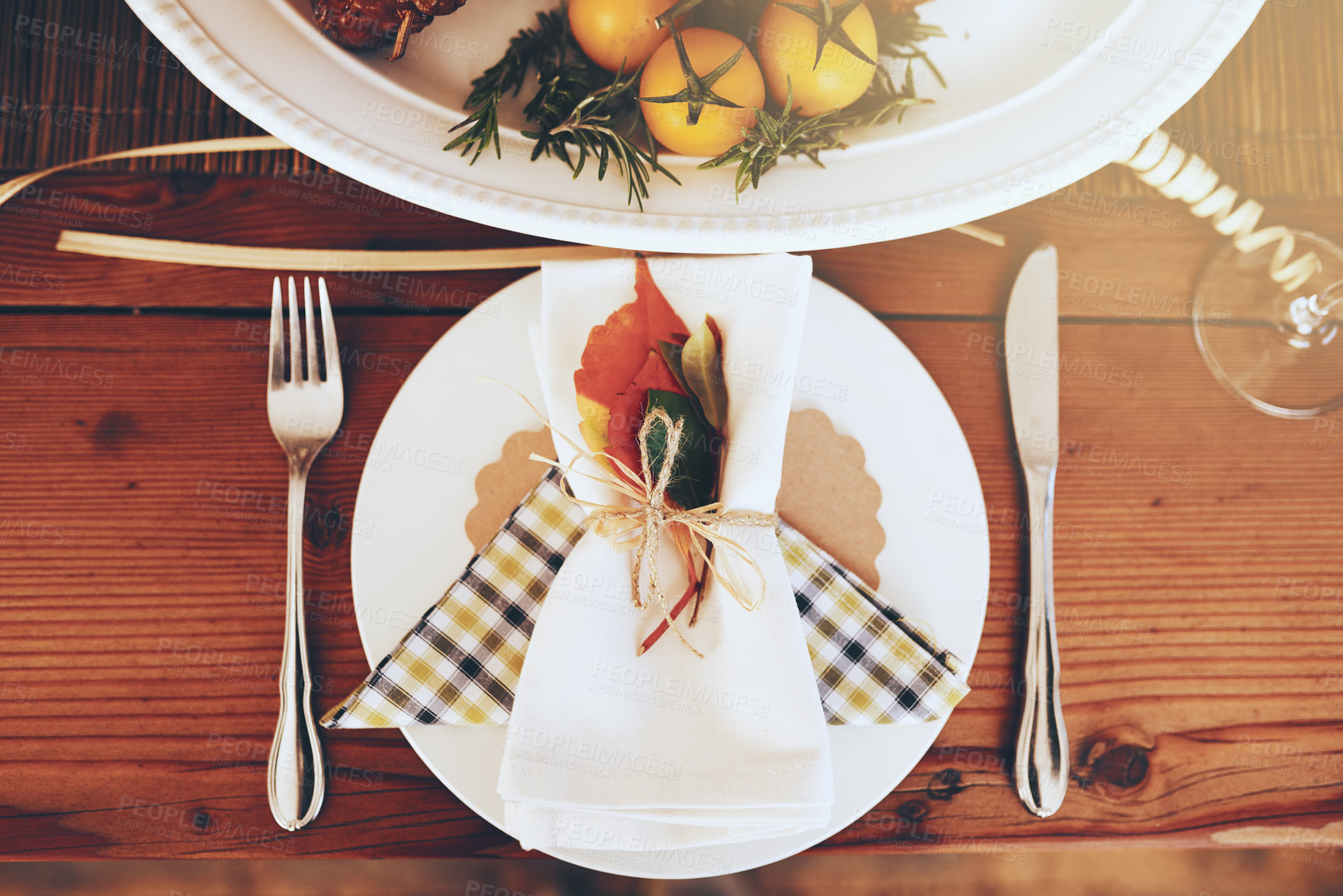 Buy stock photo Plate, Christmas and celebration with a table setting on a wooden surface in the festive season from above. Party, still life and cutlery with a napkin on a serving dish in an empty home with flare