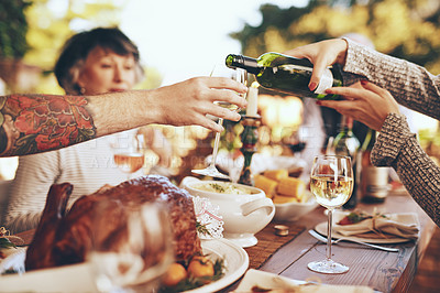 Buy stock photo Dinner, party and celebrate with hands and wine, wine glass to pour for drink, people with food outdoor, holiday or anniversary celebration. Festive, event and table with feast, friends and family.