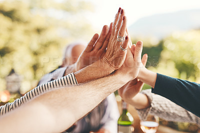 Buy stock photo Support, high five and community with hands of family at dinner table for celebration, happy and lunch together. Collaboration, faith and festive with friends relax for solidarity, unity and pride