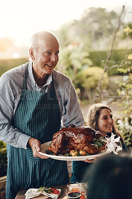 Buy stock photo Chicken, celebration and man serving lunch on Christmas holiday, family gathering and event in a backyard. Food, cooking and chef with a turkey for hungry people at a Thanksgiving dinner party