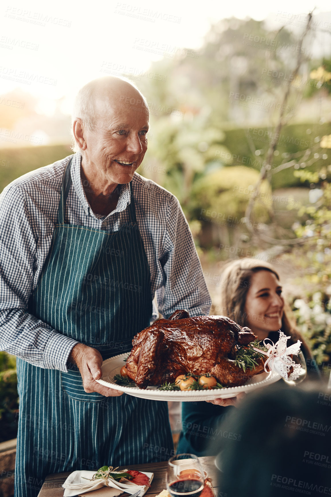 Buy stock photo Chicken, celebration and man serving lunch on Christmas holiday, family gathering and event in a backyard. Food, cooking and chef with a turkey for hungry people at a Thanksgiving dinner party