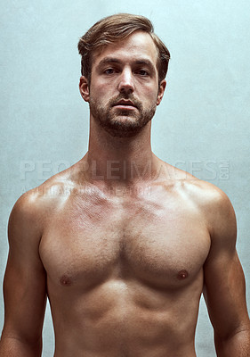 Buy stock photo Man, chest and fitness in studio portrait, strong pectorals and muscle on blue background. Male person, confident and athlete for power training or healthy body, bodybuilder and topless for wellness