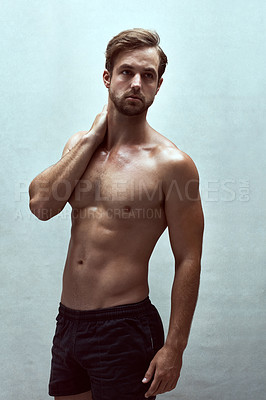 Buy stock photo Shot of a handsome bare-chested young man posing in the studio