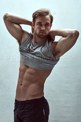 Buy stock photo Shot of a handsome bare-chested young man posing in the studio