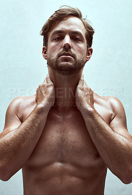 Buy stock photo Shot of a handsome bare-chested young man posing in the studio