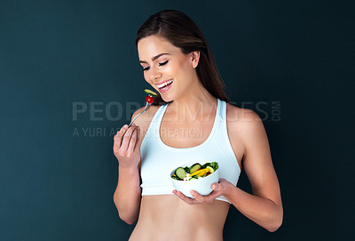 Buy stock photo Happy woman, salad bowl and eating for diet, lose weight or natural nutrition in fitness against a studio background. Female person or model smile with vegetables for food or healthy meal on mockup