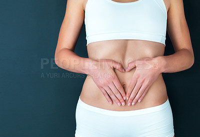 Buy stock photo Woman, hands and stomach in fitness, lose weight or diet against a studio background. Closeup of female person or model holding tummy for body care, liposuction or natural nutrition on mockup space