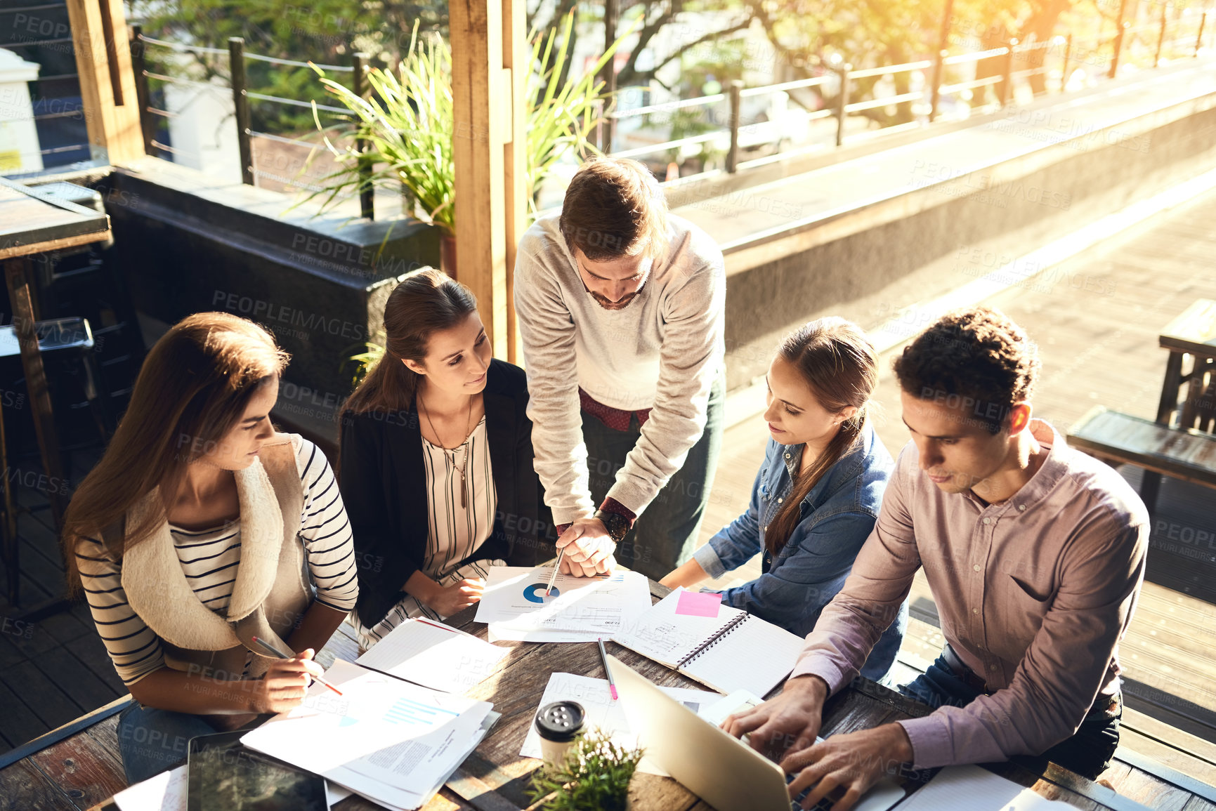 Buy stock photo Business, group and ideas in meeting, outdoor and discussion for project, graph and laptop in cafe. Planning, SEO and teamwork of people with stats, creative or typing of information and paperwork