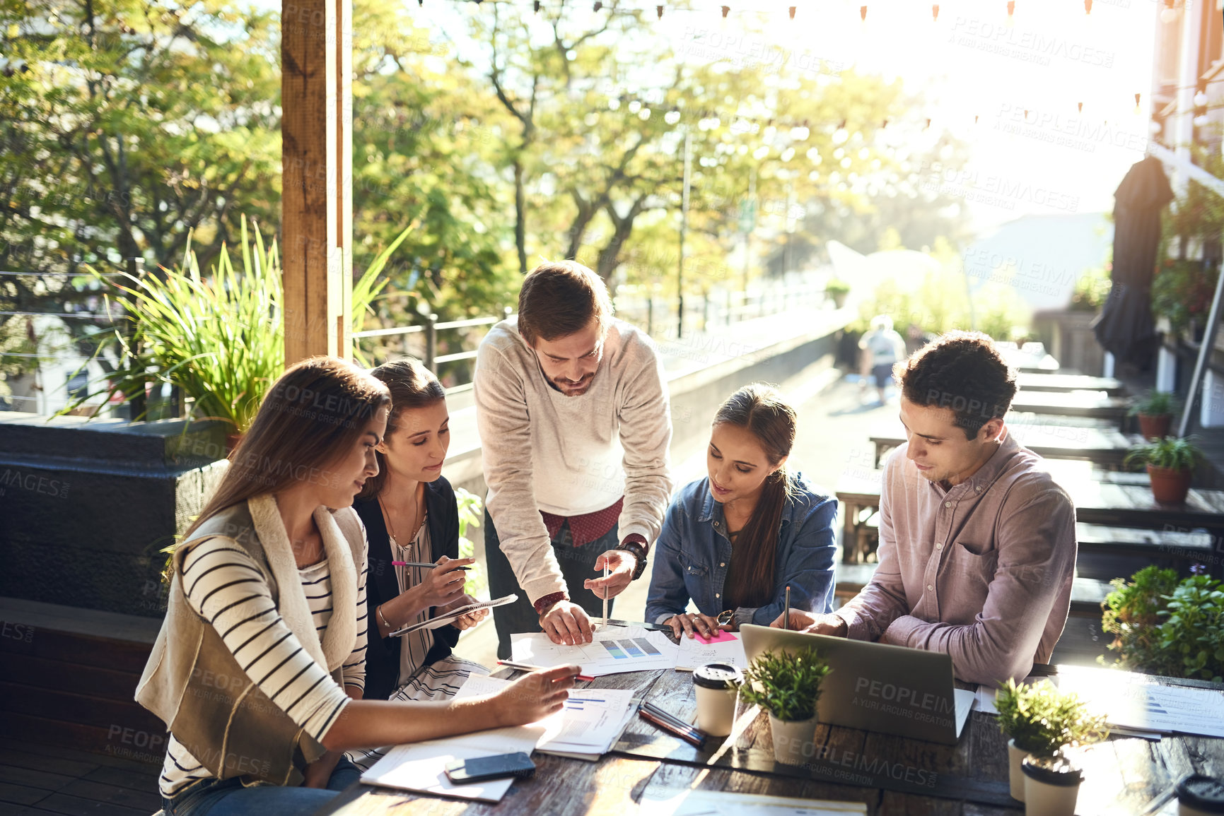 Buy stock photo Business, group and notes in meeting, outdoor and ideas for project, graph and laptop in cafe. Planning, SEO and teamwork of people with stats, creative or typing of information and paperwork