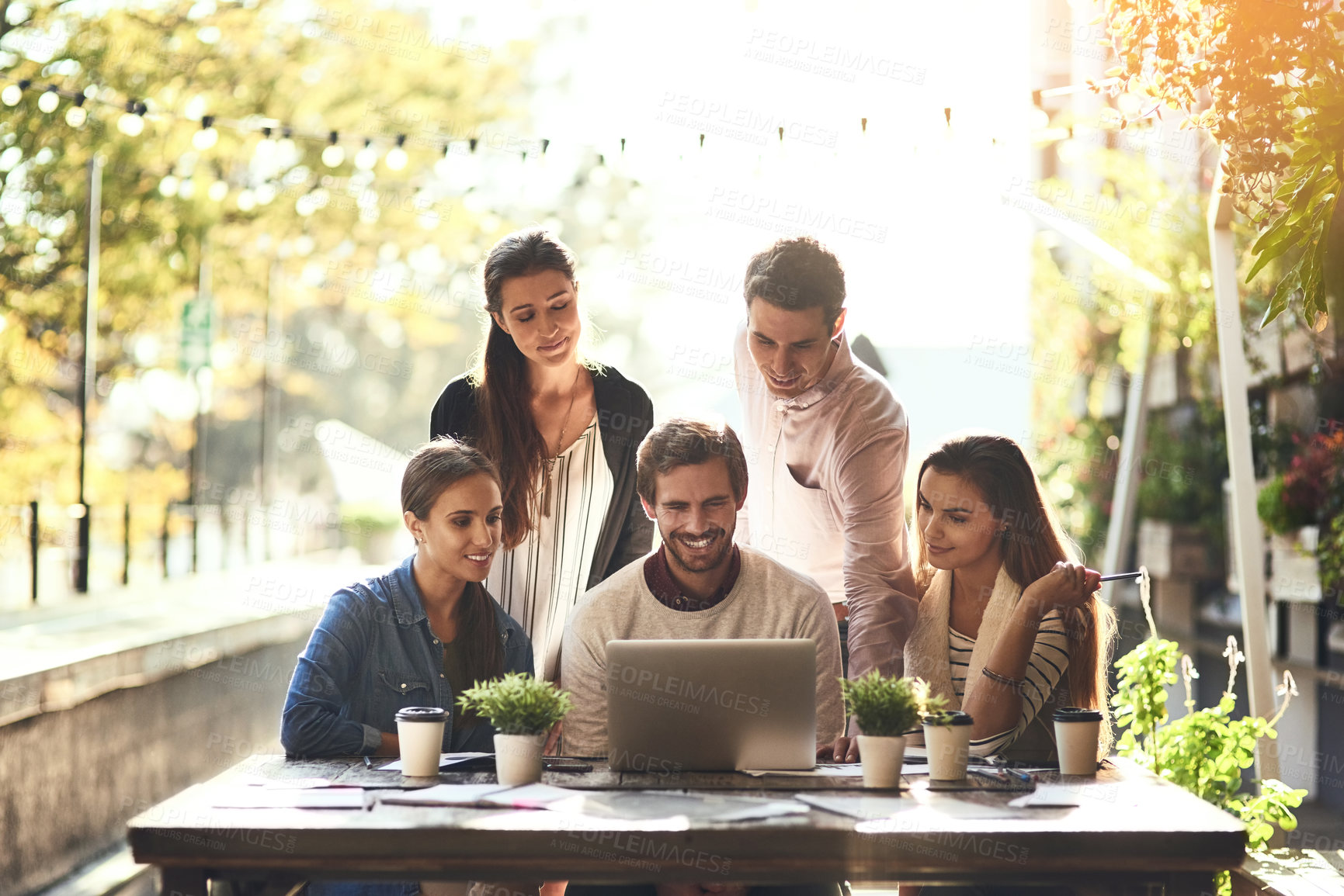 Buy stock photo Outdoor cafe, teamwork and business people in meeting, laptop and cooperation with brainstorming, review or feedback. Group, employees or coworkers with pc, project or sunshine with creative agency