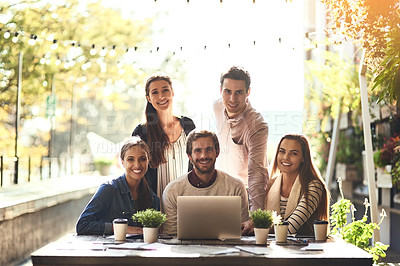 Buy stock photo Cropped portrait of a team of colleagues using a laptop together during a meeting at an outdoor cafe