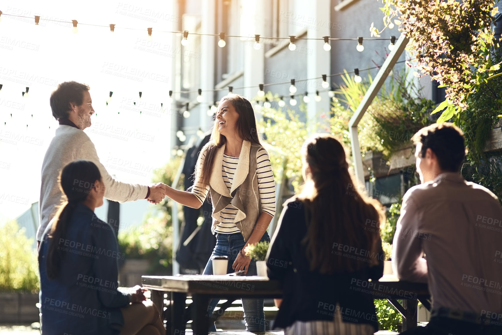 Buy stock photo Business people, greeting and handshake in meeting at restaurant for welcome, b2b networking or remote work outdoor. Teamwork, happy and shaking hands for onboarding, partnership deal or agreement
