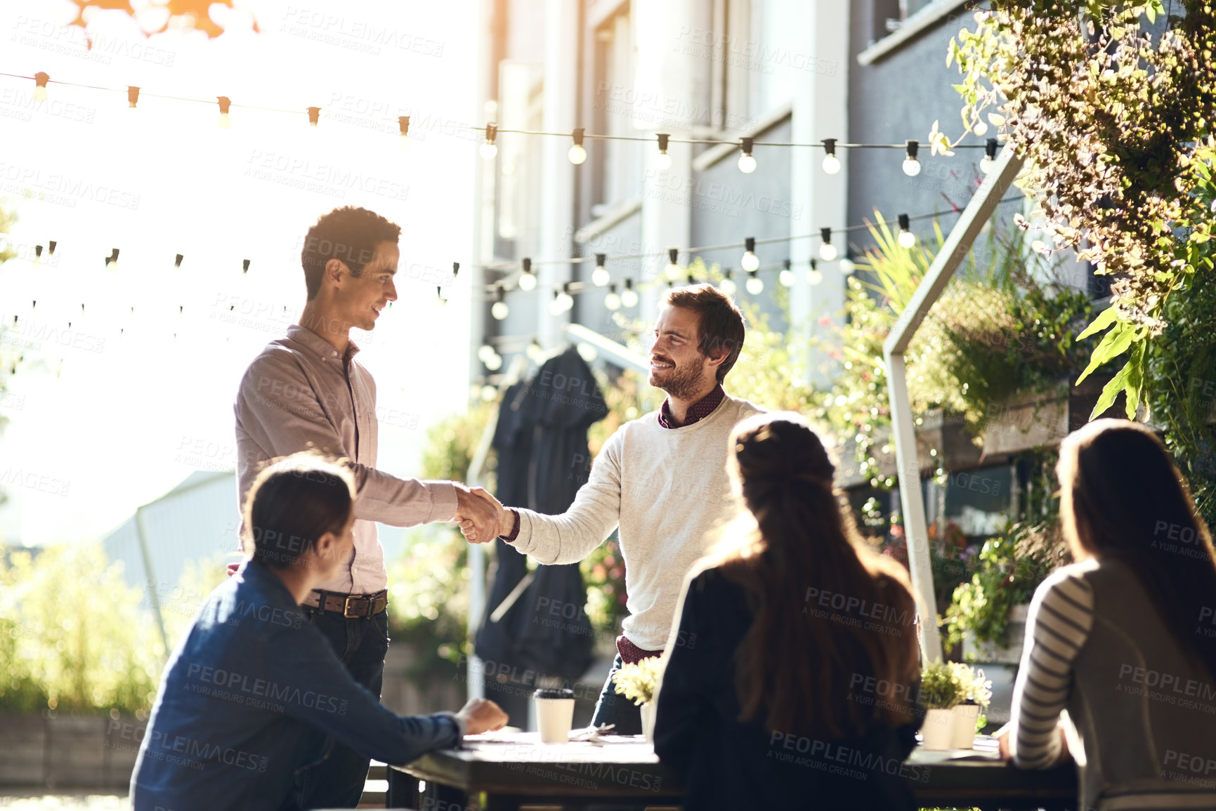 Buy stock photo Business people, men and shaking hands in meeting at cafe for welcome, b2b networking and collaboration outdoor. Group, employees and handshake for onboarding, partnership deal or happy for agreement