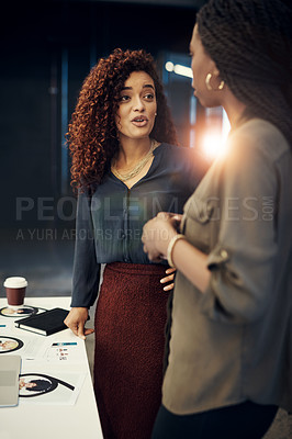 Buy stock photo Shot of two businesswomen having a discussion at the office