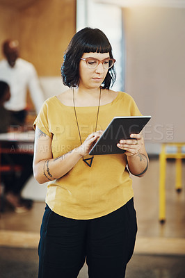 Buy stock photo Cropped shot of a businesswoman using a digital tablet while at the office