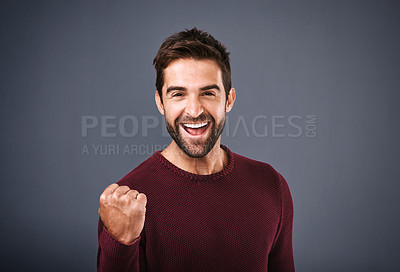 Buy stock photo Success, winner and happy man in studio celebration, achievement or yes for bonus or lottery. Excited casual person in portrait with fist, power or shouting for news or opportunity on gray background