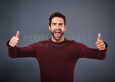 Buy stock photo Man, success and thumbs up in studio for winning, support and like or yes for achievement. Portrait of excited person shouting, cheering and motivation with good luck and voting on gray background