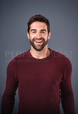 Buy stock photo Studio, confidence and man with smile, portrait and fashion of sweater, organic cotton and excited. Grey background, face and happiness of person, proud and calm with jersey, joy and trendy style