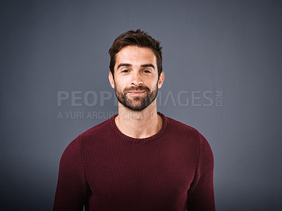 Buy stock photo Studio shot of a handsome and confident young man posing against a gray background