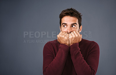 Buy stock photo Scared, afraid and phobia of man in studio, anxiety and biting of nails for stress, worry and fear. Gray background, mockup space and person with terror for nightmare of fail in test of college