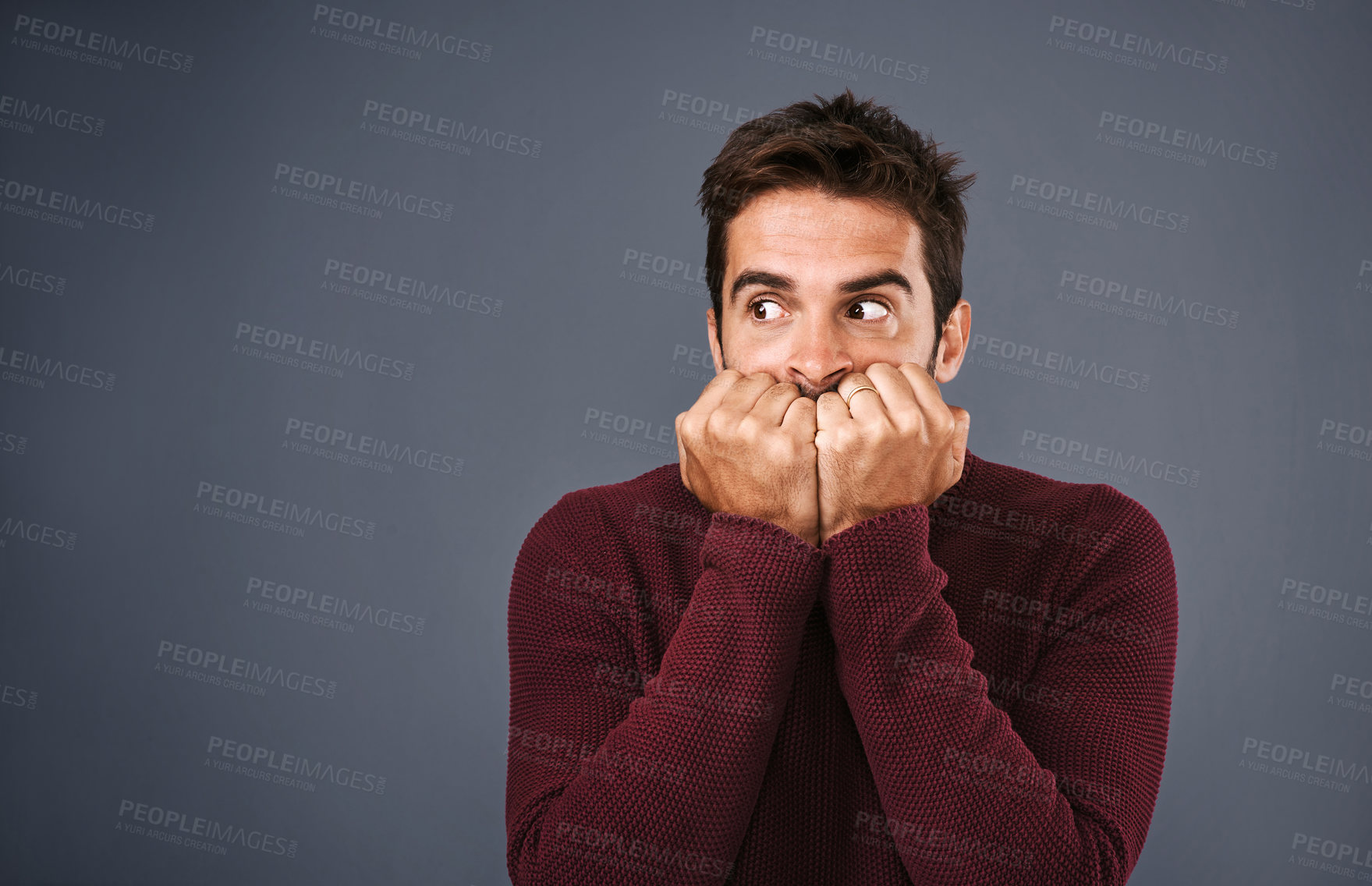 Buy stock photo Scared, afraid and phobia of man in studio, anxiety and biting of nails for stress, worry and fear. Gray background, mockup space and person with terror for nightmare of fail in test of college