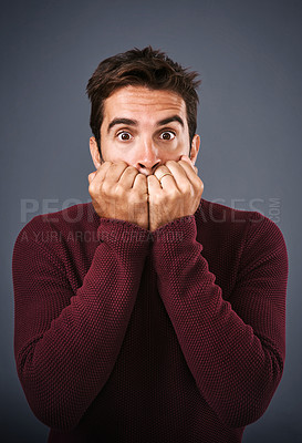 Buy stock photo Portrait, scared and phobia of man in studio, anxiety and biting of nails for stress, afraid and fear. Gray background, mental health and person with terror for nightmare of fail in test of college