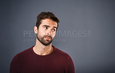 Buy stock photo Doubt, thinking and face of unsure man in studio with worry, uncertain and thoughtful on gray background. Confused, mockup space and isolated male person skeptical for decision, choice and question