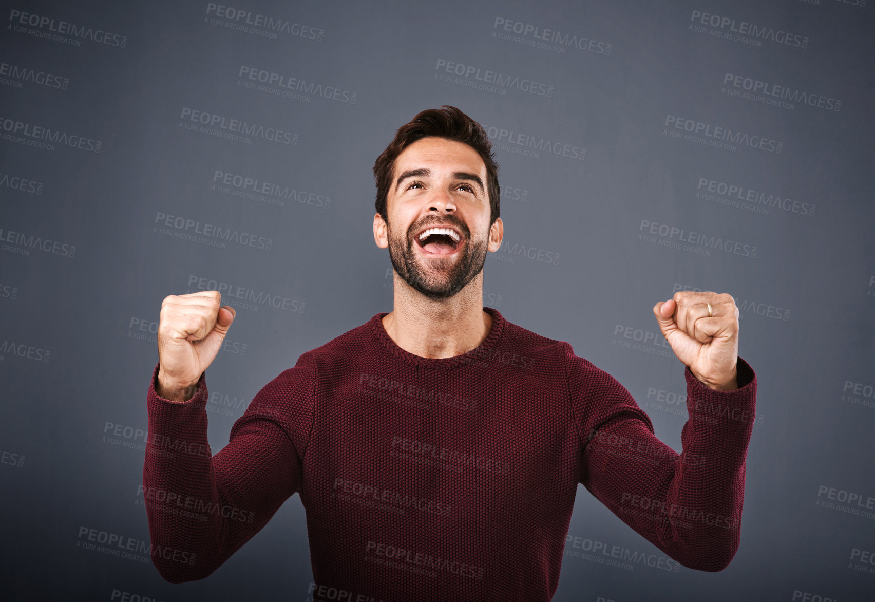 Buy stock photo Happy man, fist pump and winning with celebration for good news, vote or review on a blue studio background. Excited male person, young model or winner in hooray for success, victory or achievement