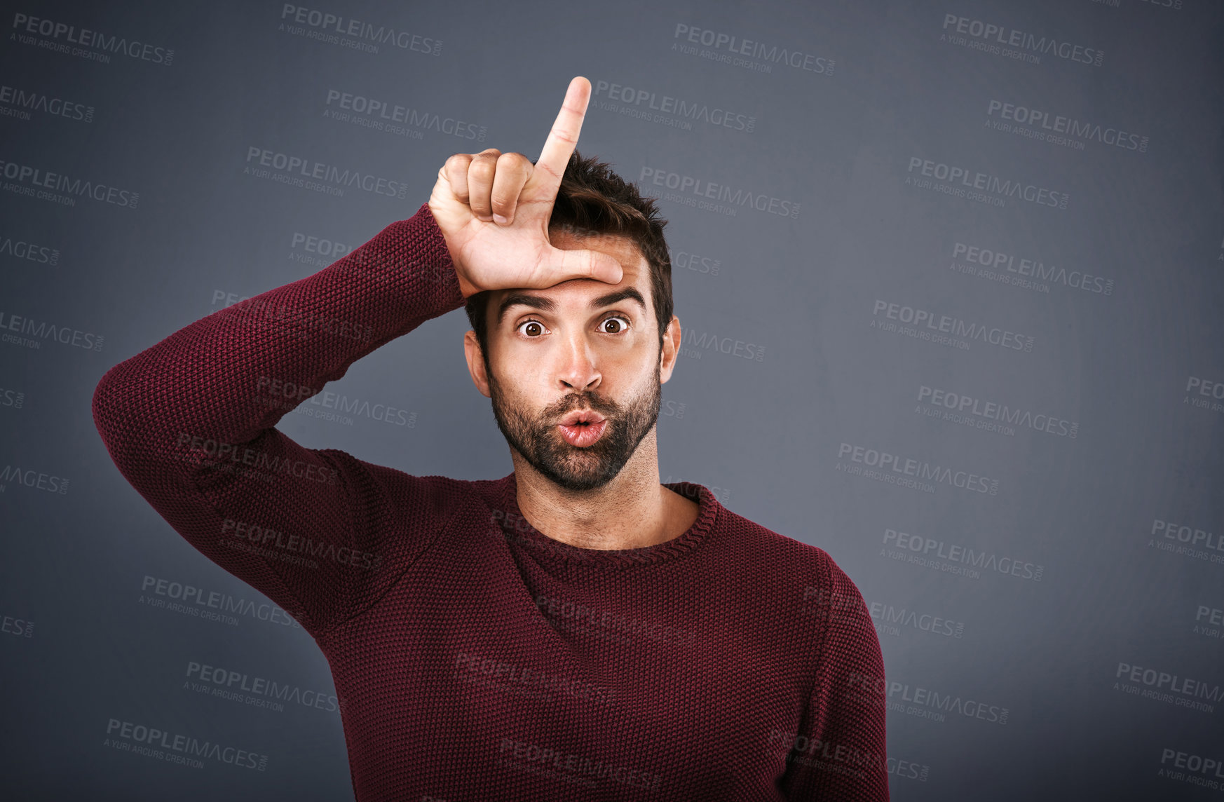 Buy stock photo Studio, portrait and man with loser symbol for feedback, opinion and wrong decision with emoji reaction. Facial expression, hand gesture and male person with silly for review, sign or gray background