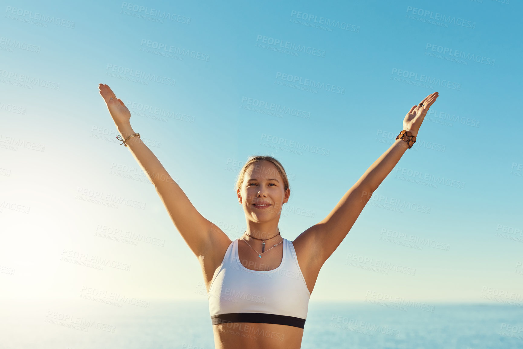 Buy stock photo Shot of a young woman doing yoga at the beach