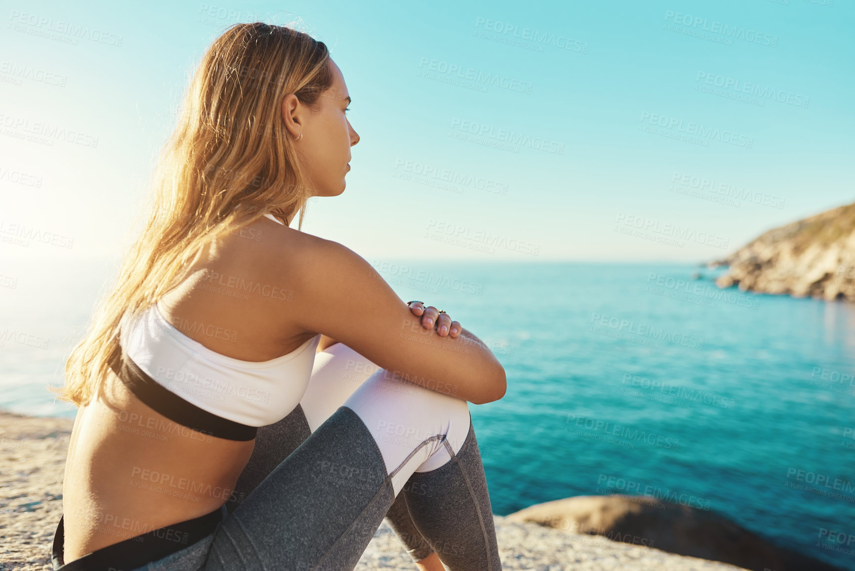 Buy stock photo Shot of an athletic young woman practicing yoga on the beach