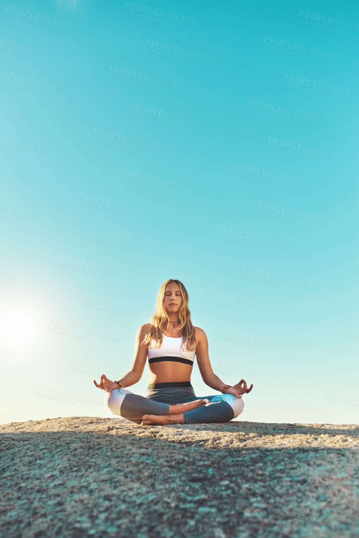 Buy stock photo Cliff, meditation and woman with zen for yoga, wellness and spiritual peace in California. Chakra, female yogi and hands with lotus pose for calm, relaxing and mental health by rock outdoors in beach