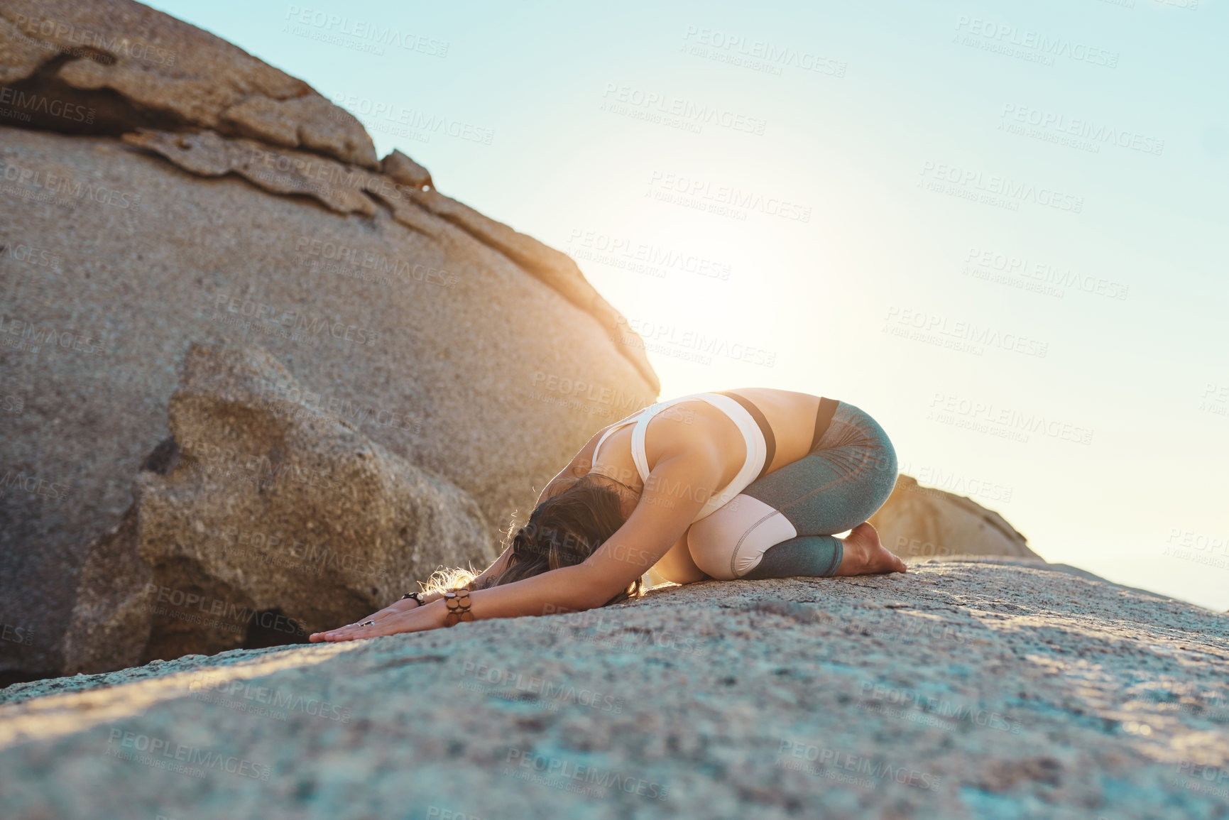 Buy stock photo Shot of a young woman doing yoga at the beach