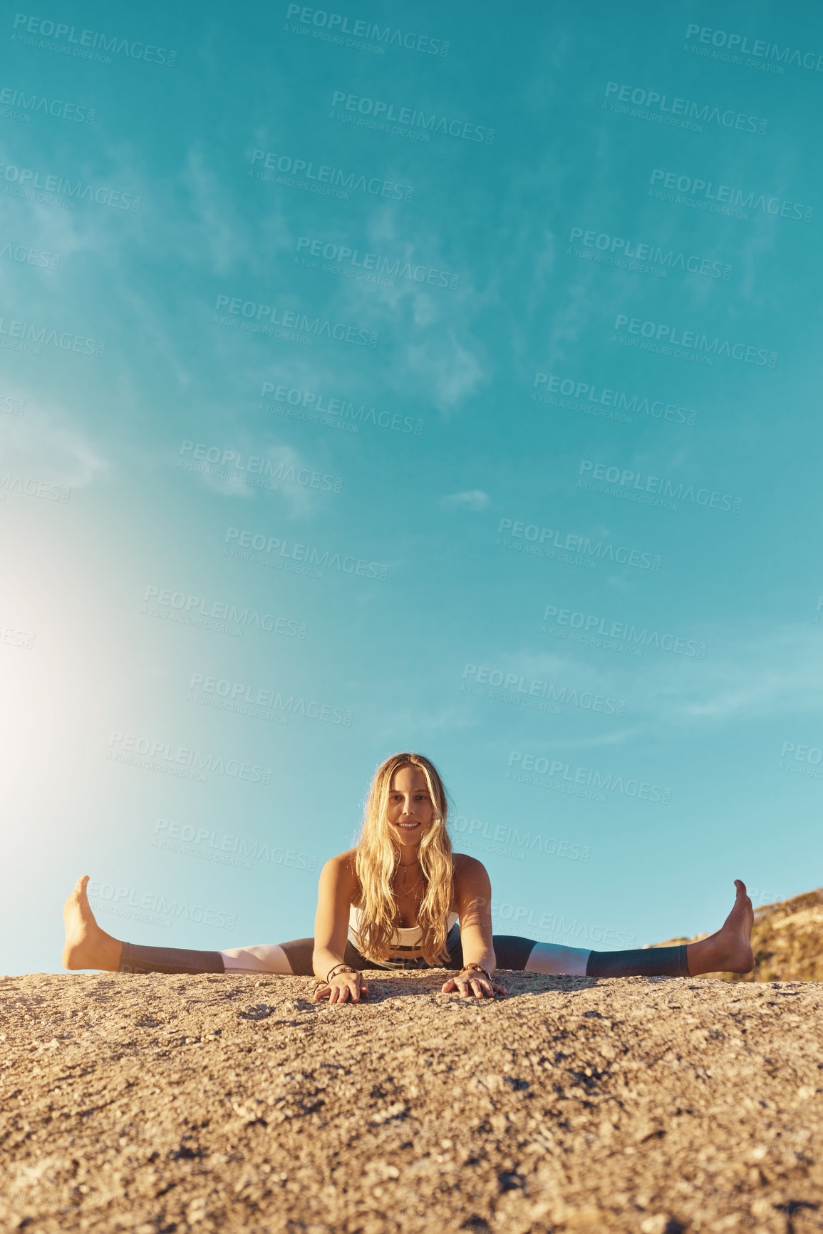 Buy stock photo Shot of an athletic young woman practicing yoga on the beach