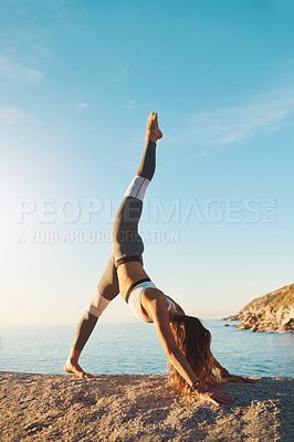 Buy stock photo Woman, stretching and pilates fitness or beach exercise, yoga and standing splits position for body health. Wellness, balance workout and seaside for peace outside in nature, vitality and zen on rock