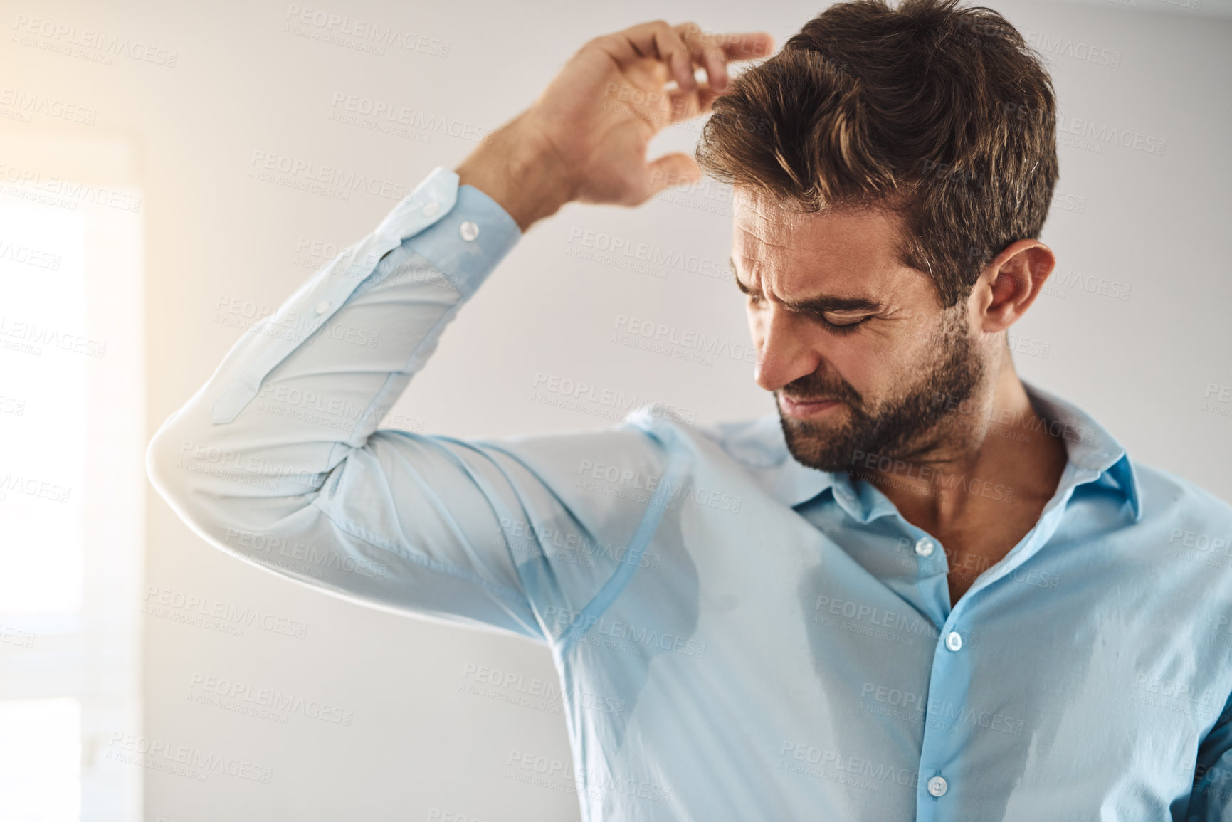 Buy stock photo Man, smell armpit and home for bad aroma, morning grooming and employee getting ready for work. Male person, foul and inhale scent of sweat or dirty underarm, professional and hygiene mistake or fail