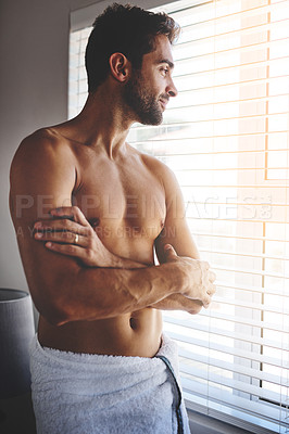 Buy stock photo Cropped shot of a handsome young man in a towel with his arms folded in his bedroom at home