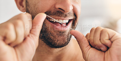 Buy stock photo Closeup, face and man flossing teeth at home for healthy dental wellness, plaque and gingivitis. Happy guy, oral thread or cleaning mouth for fresh breath, tooth hygiene and habit to care for smile
