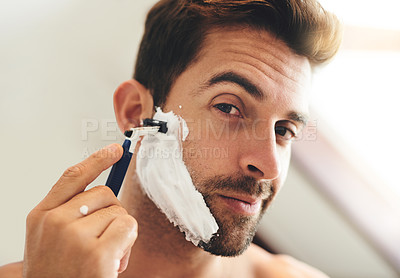 Buy stock photo Portrait, man and shaving face with razor for hair removal, aesthetic skincare and morning facial cleaning at home. Closeup of guy, foam and and shave with cream cosmetics, blade or beard in bathroom