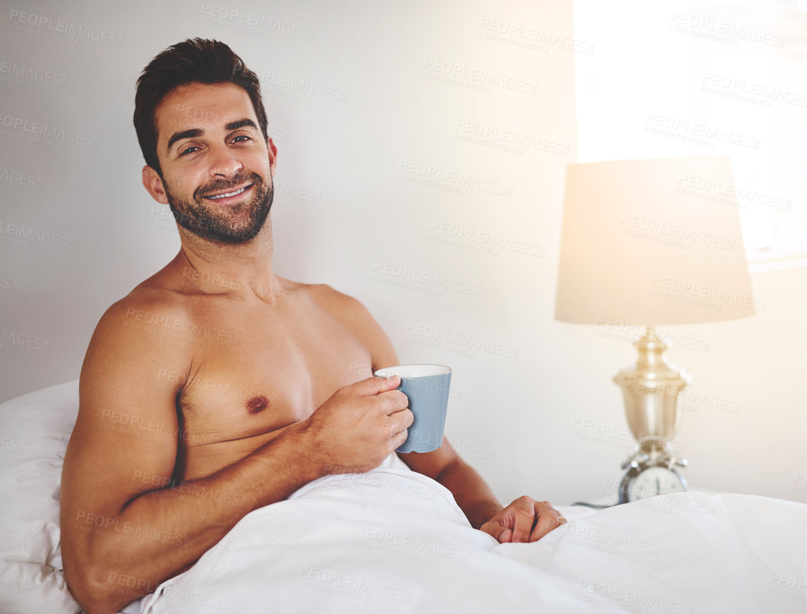 Buy stock photo Man portrait, wake up and coffee cup in home, relax and morning espresso in bedroom for energy. Male person, shirtless and mug of cappuccino in bed, hot beverage and blanket for peace in Portugal