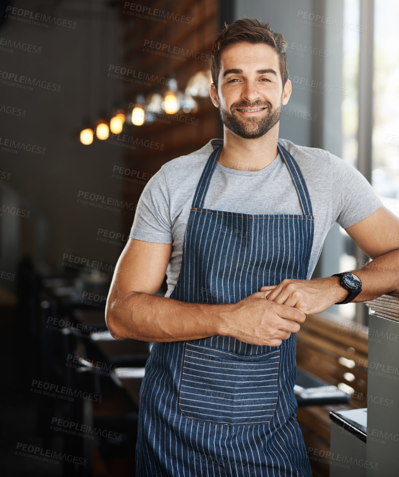 Buy stock photo Portrait of a confident young man working in a cafe