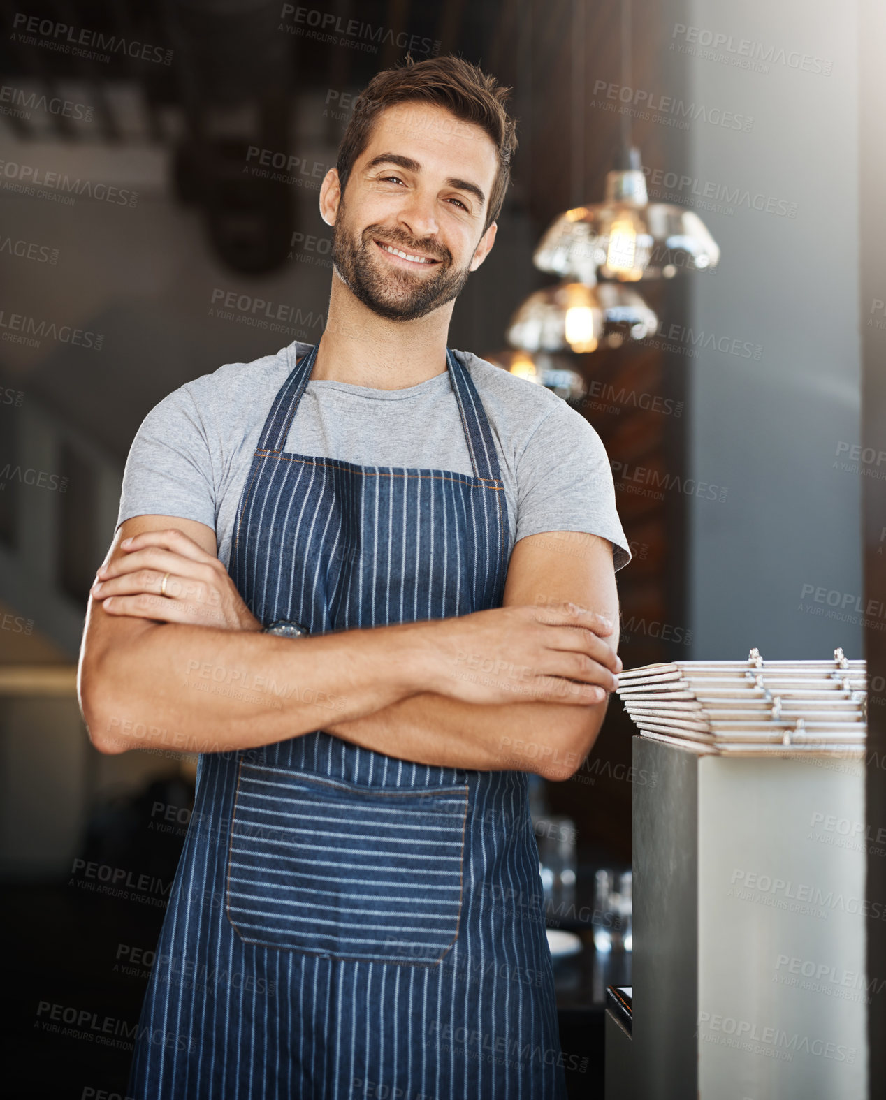 Buy stock photo Portrait, professional and man in cafe, apron and waiter with confidence, arms crossed and hospitality. Face, happy person and business owner with service industry, smile and server in restaurant