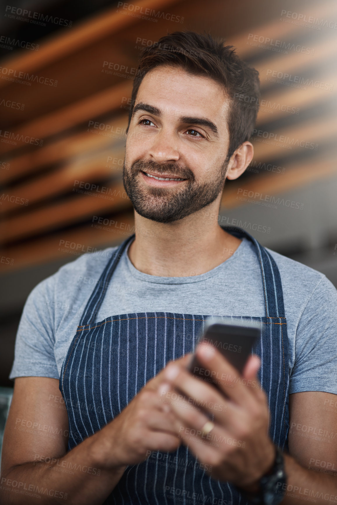 Buy stock photo Smile, man and thinking with phone at cafe for restaurant app, communication and digital service. Small business, waiter and happy with tech at coffee shop for menu update, processing or online order