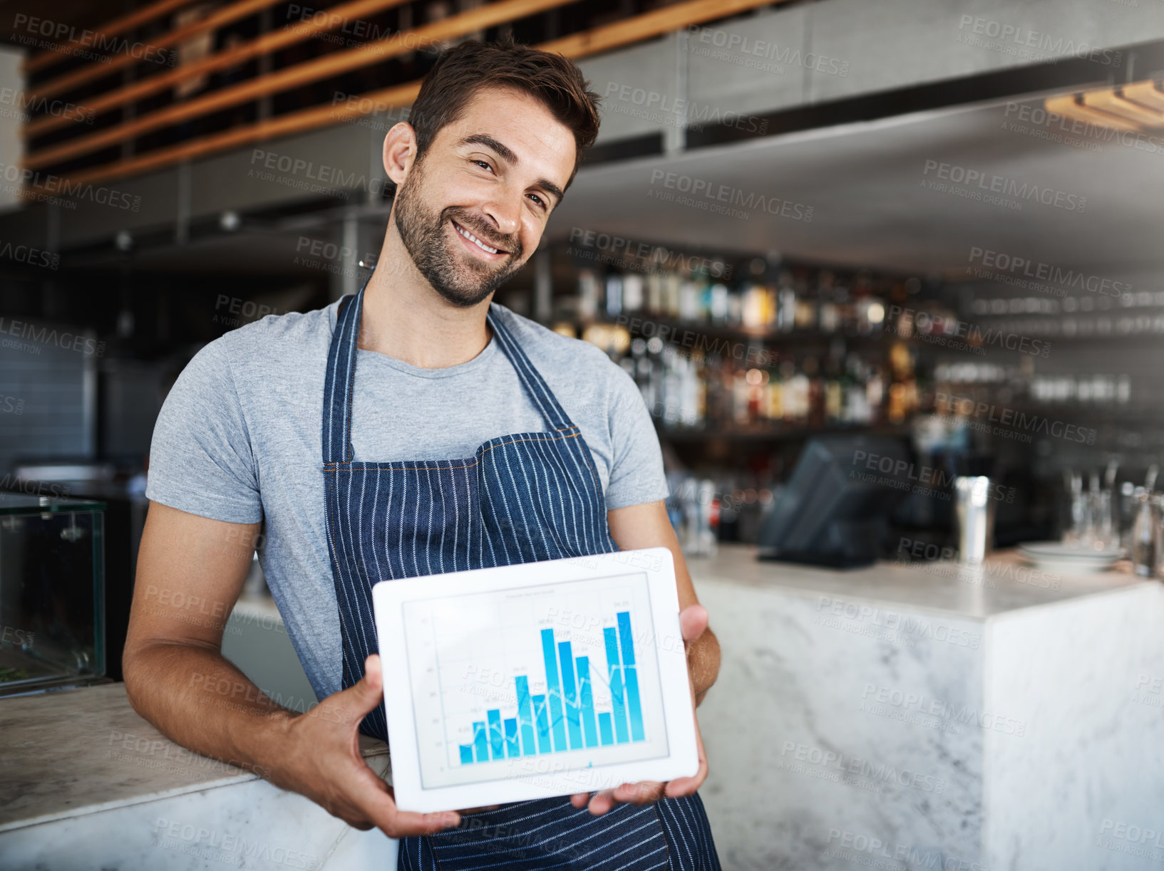 Buy stock photo Portrait of a young man holding a digital tablet with a graph on the screen at a coffee shop