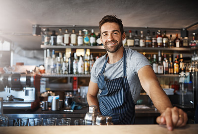 Buy stock photo Portrait of a confident young man working behind a bar counter